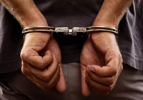 depositphotos_28109403-stock-photo-arrested-man-handcuffed-hands-at